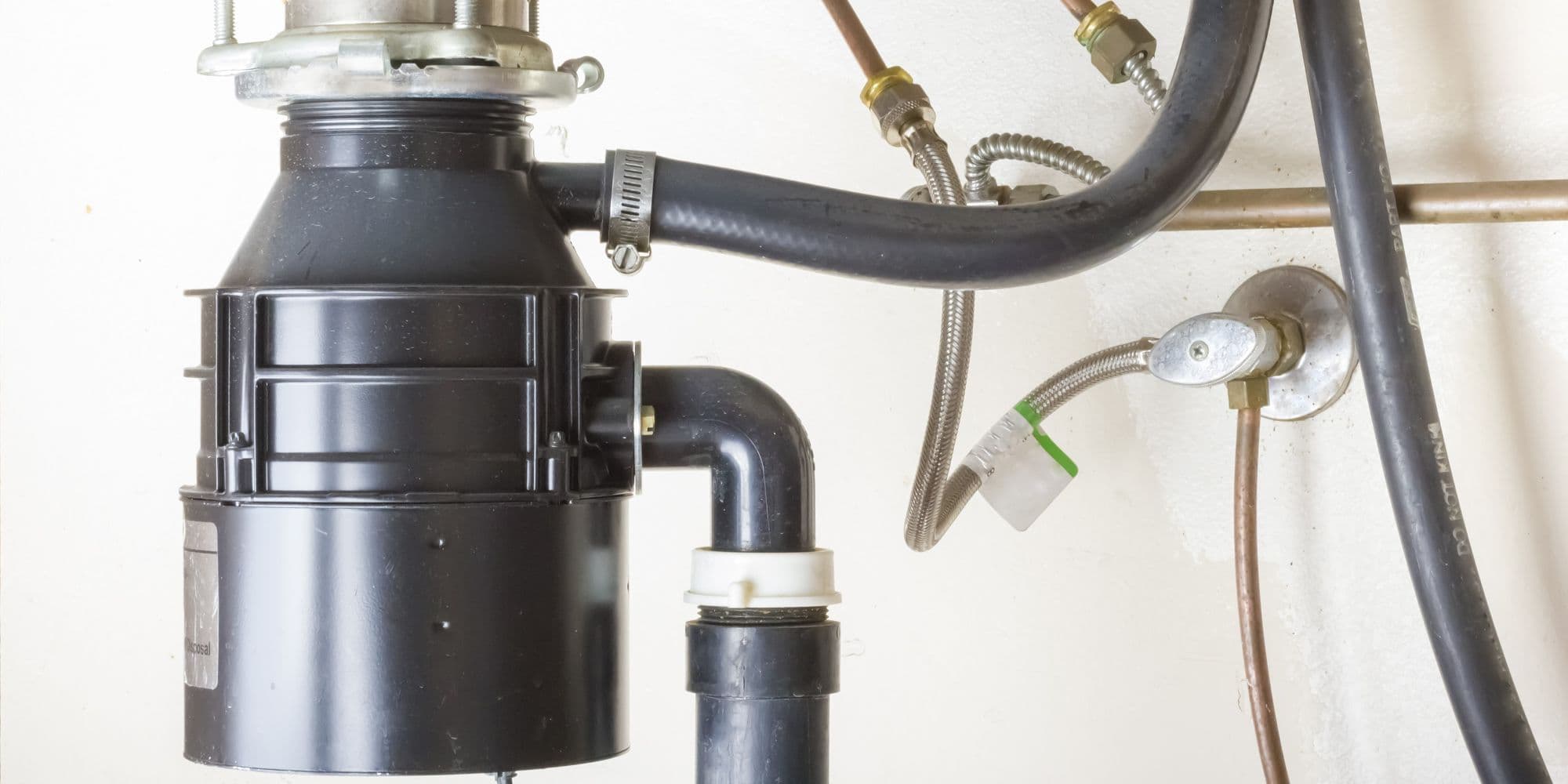 Under the sink garbage disposal unit.