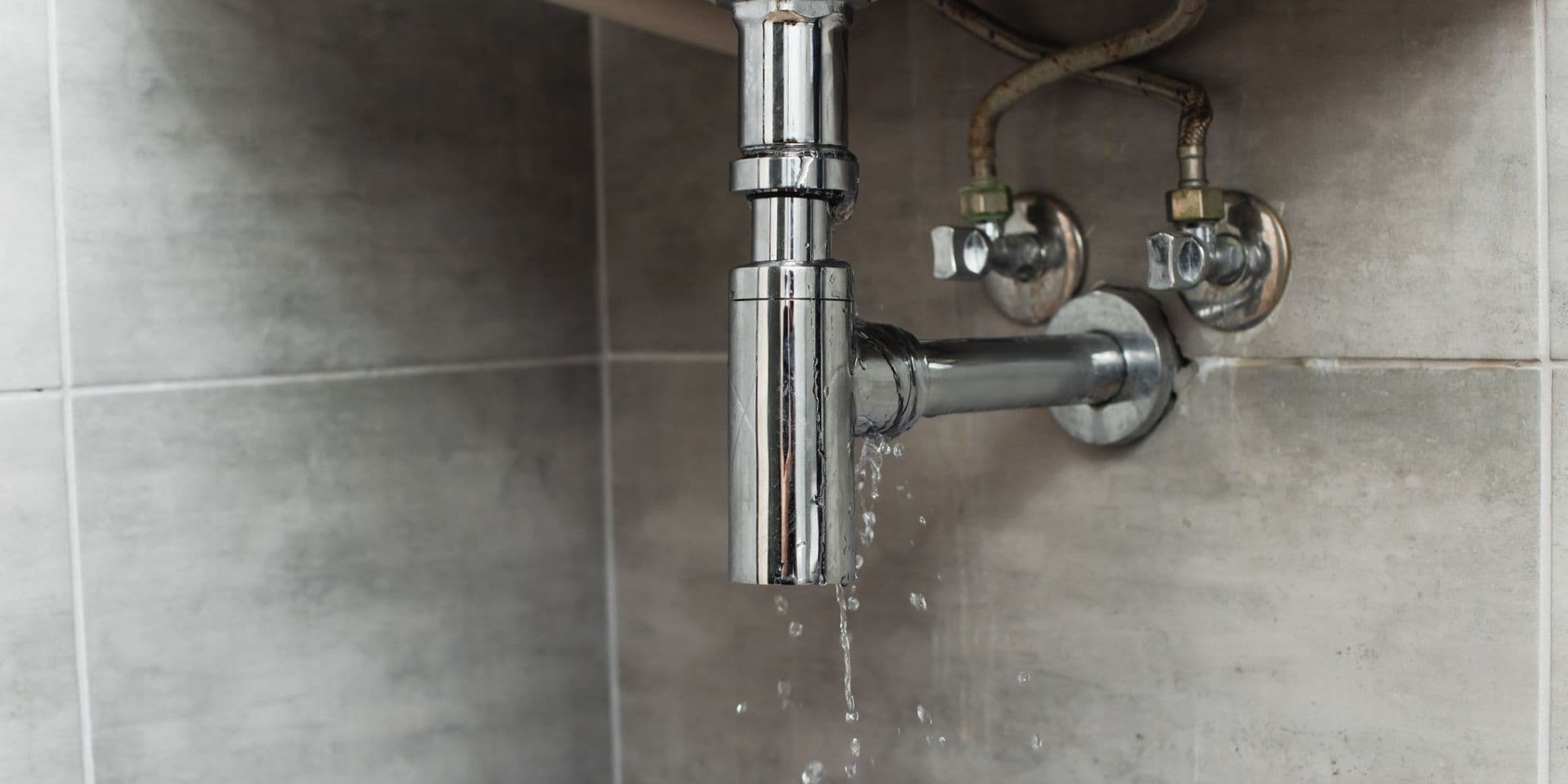Steel pipes with water drops on grey background.