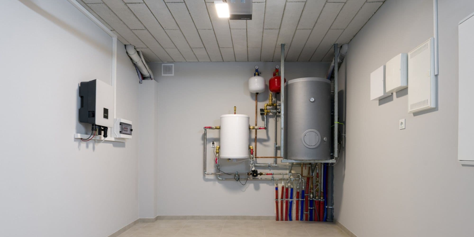 Water heater and water tank in the garage.